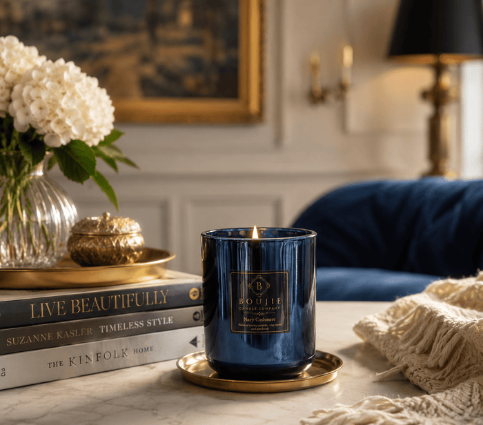 Styled photo of Boujie Navy Cashmere soy candle with pomegranate and lily accents