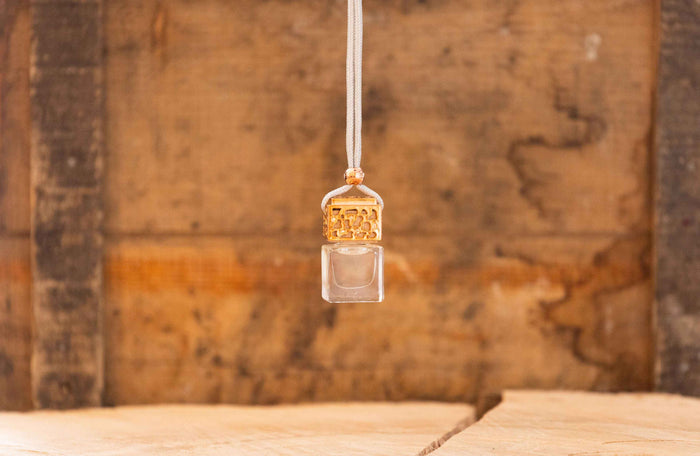Decorative car diffuser pendant with a wooden background