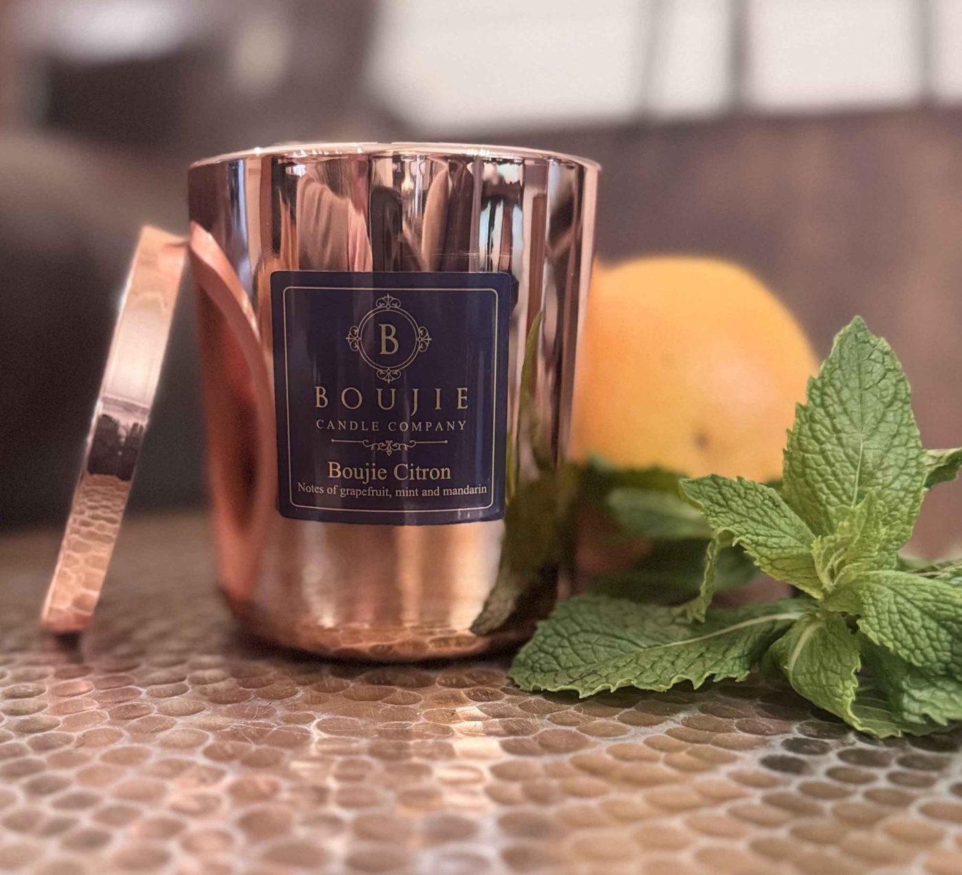 Boujie Citron candle beside fresh oranges and mint