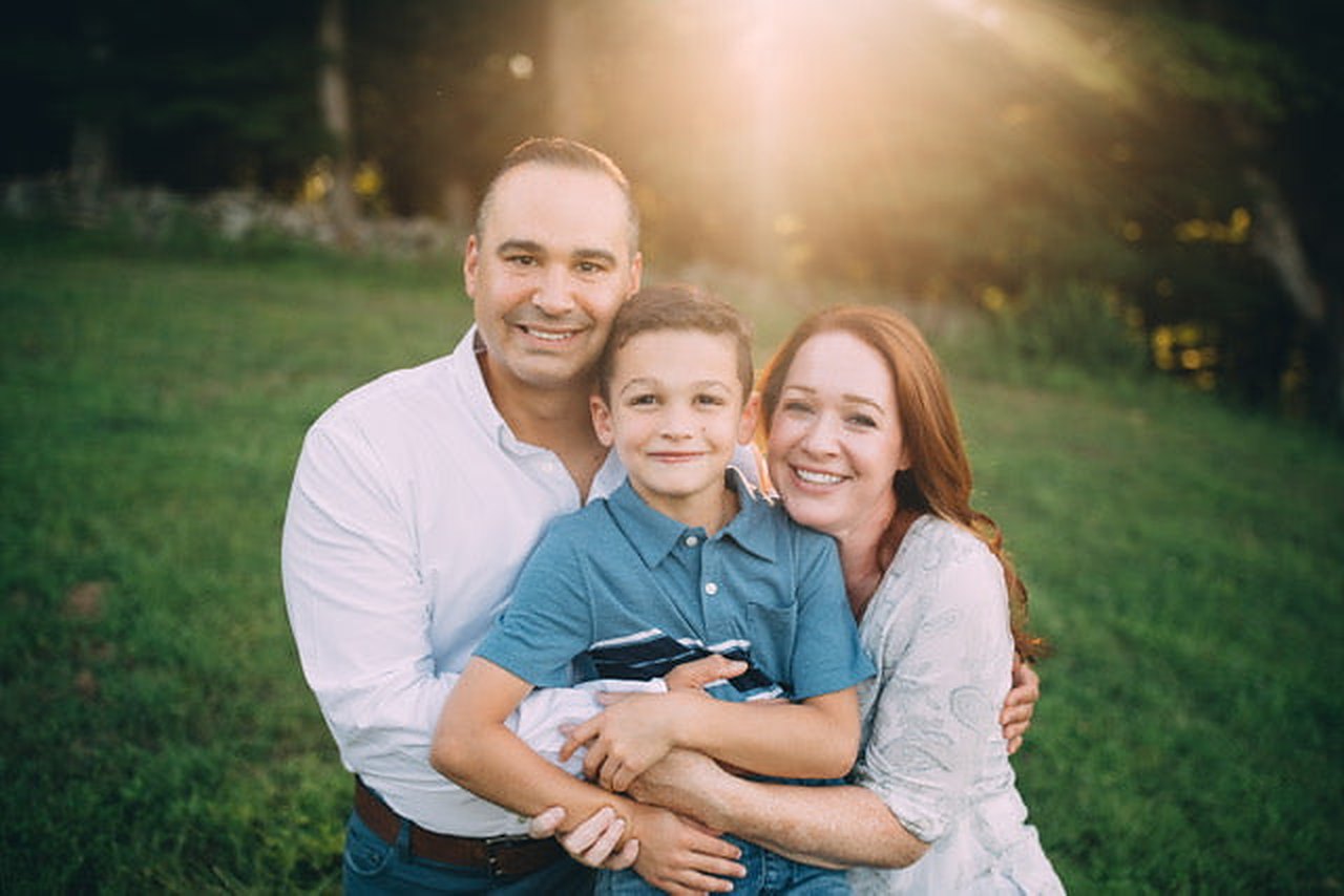 The Boujie Candle Company family — parents and son — in a sunlit field in Milford, Pennsylvania